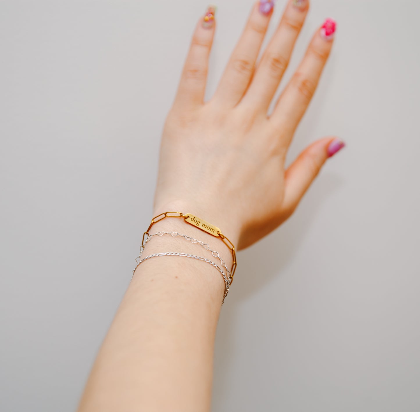 dog mom bracelet on wrist with permanent jewelry