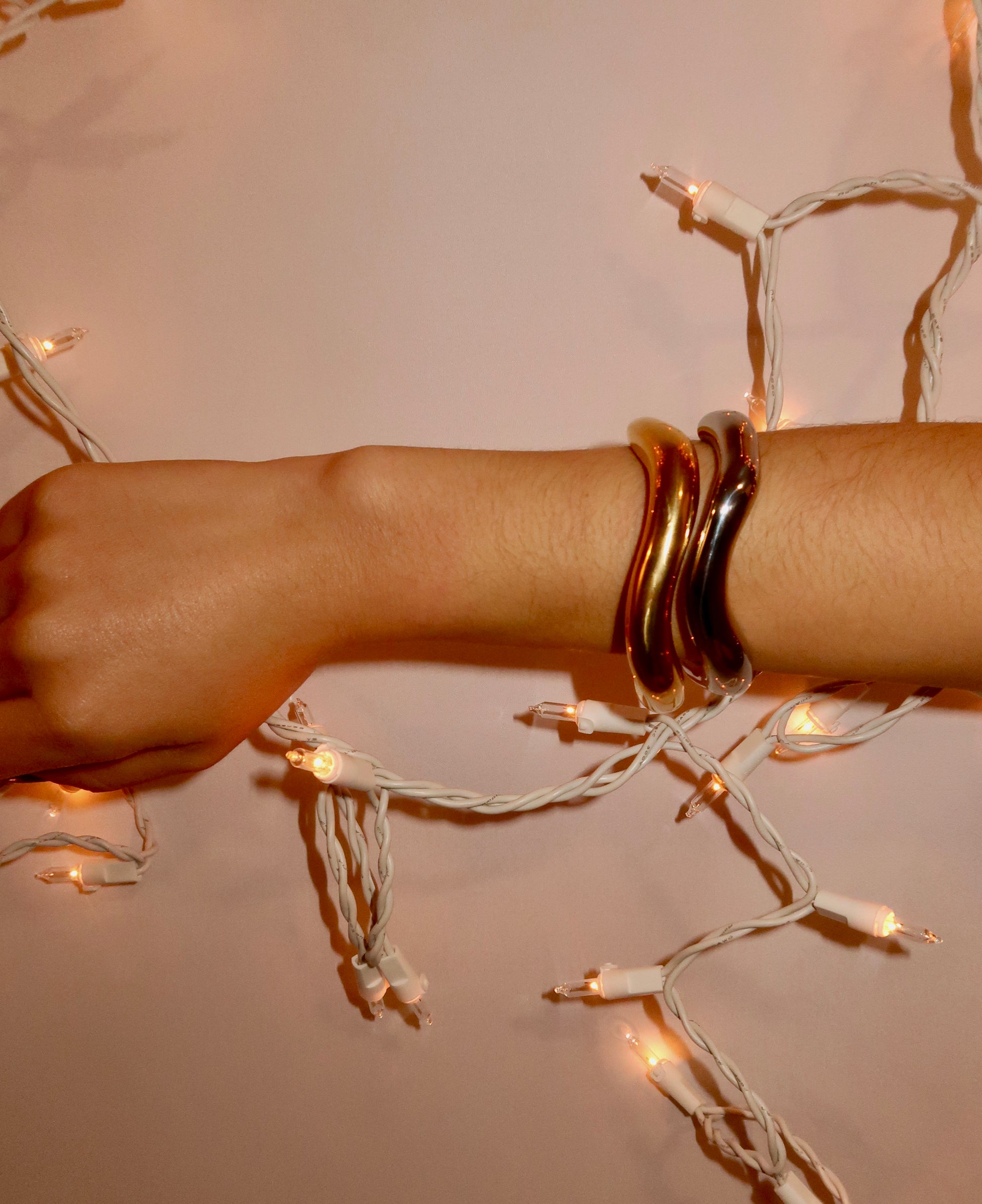 Gold minimalist bangle bracelet on model wrist – waterproof jewelry