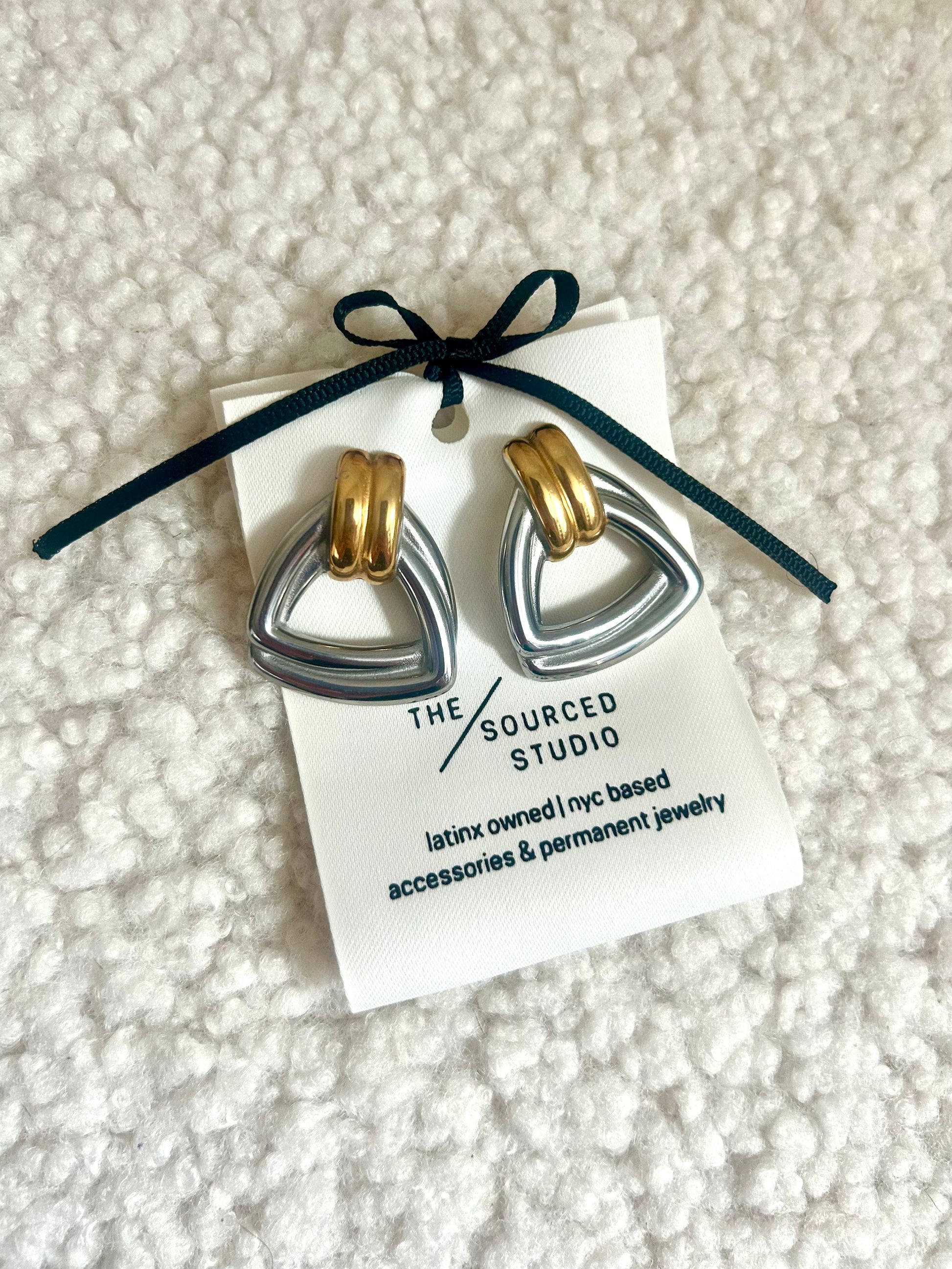 Close-up of chunky silver gold dome earrings – modern vintage jewelry