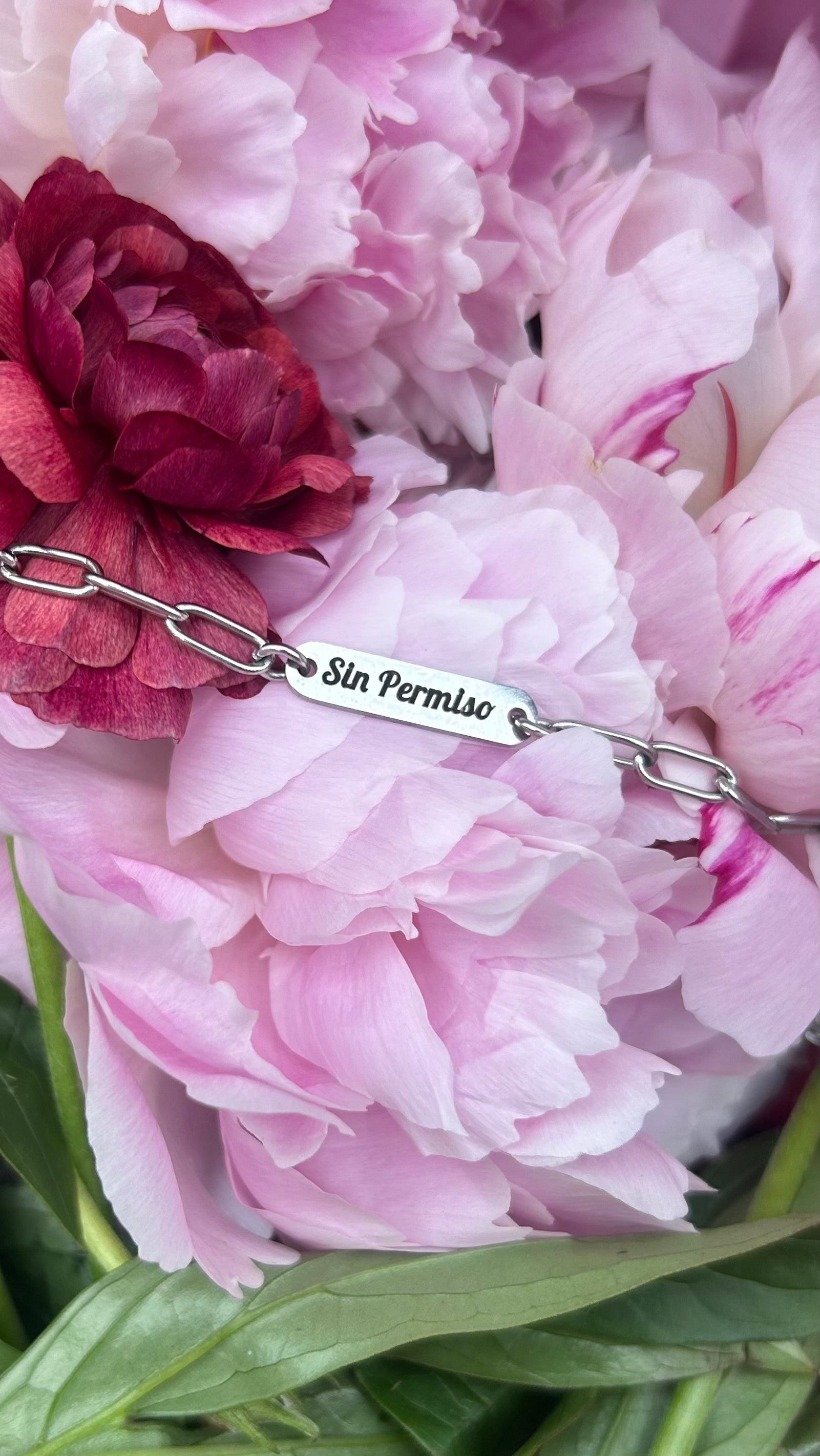 Silver Engraved Bracelet laying over a bed of flowers