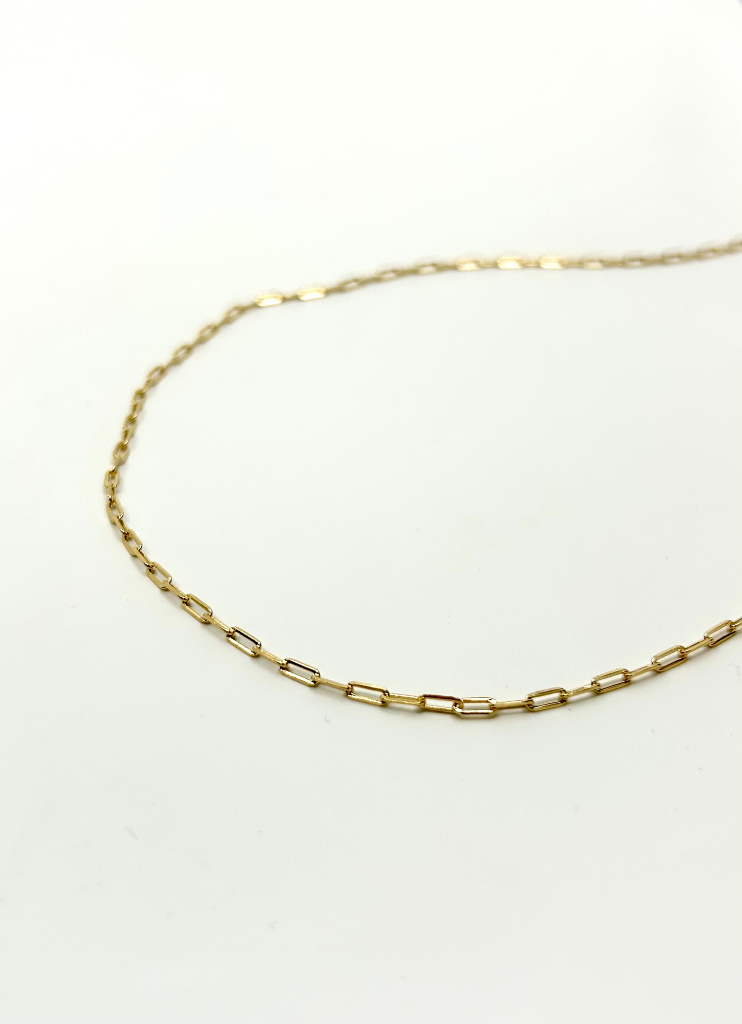 gold paperclip water proof chain on white background