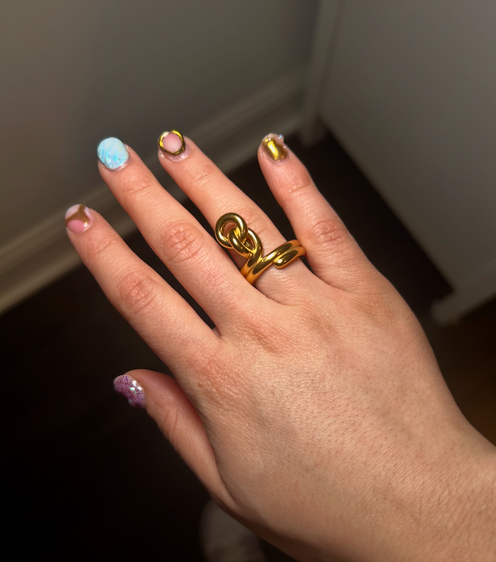 Model wearing gold knot ring – minimalist love ring in multiple sizes