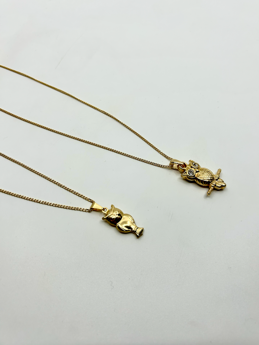 Close-up of owl pendant necklace – gold plated, symbolic jewelry