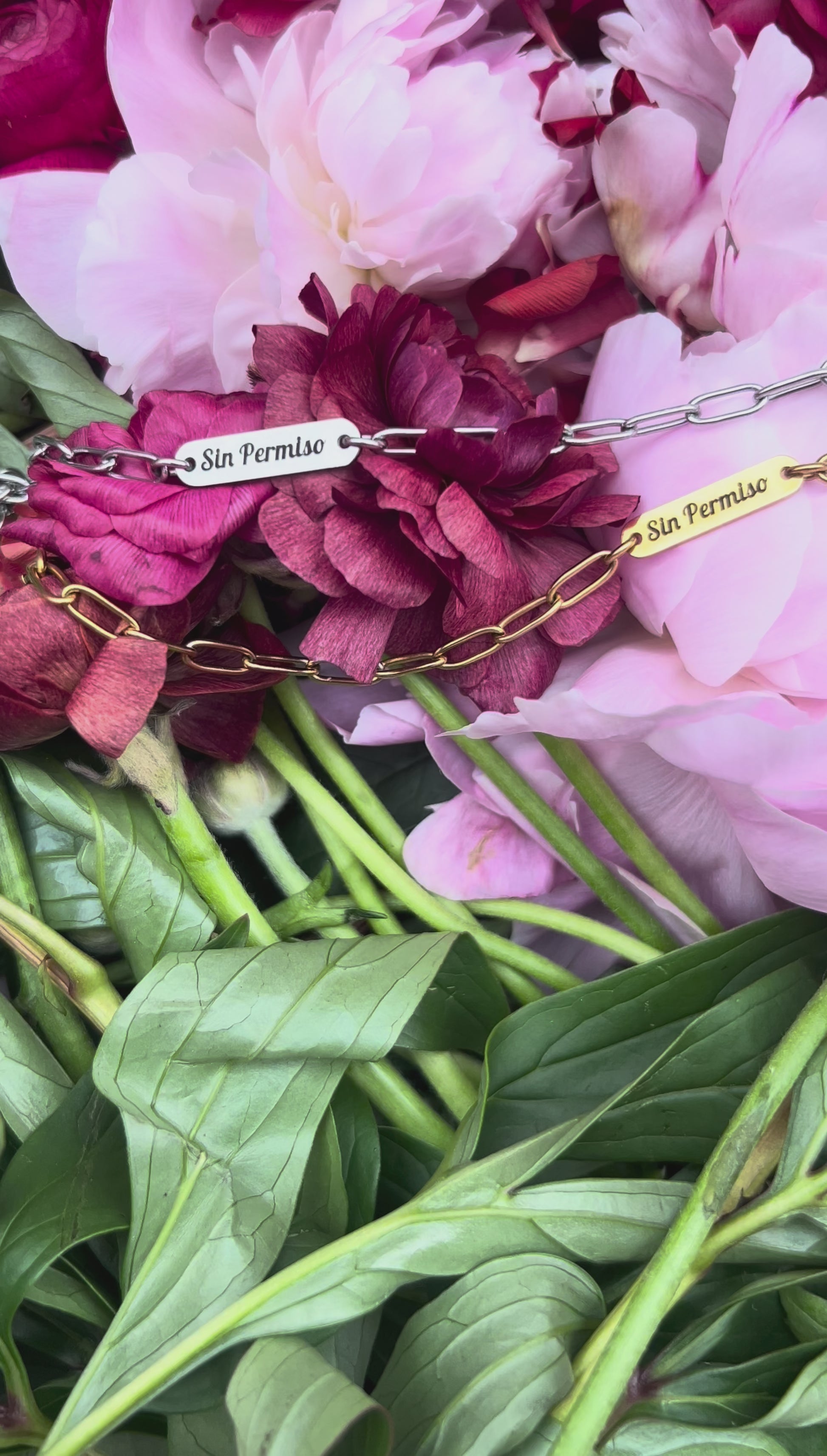 Silver and Gold Engraved Bracelet laying over a bed of flowers