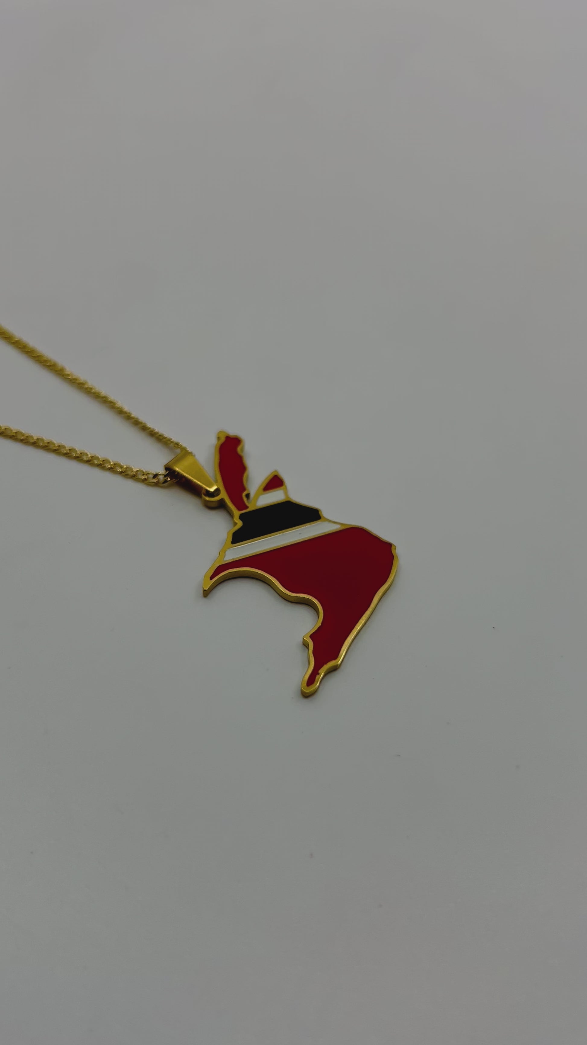 Flat lay of engraved Trinidad and Tobago necklace