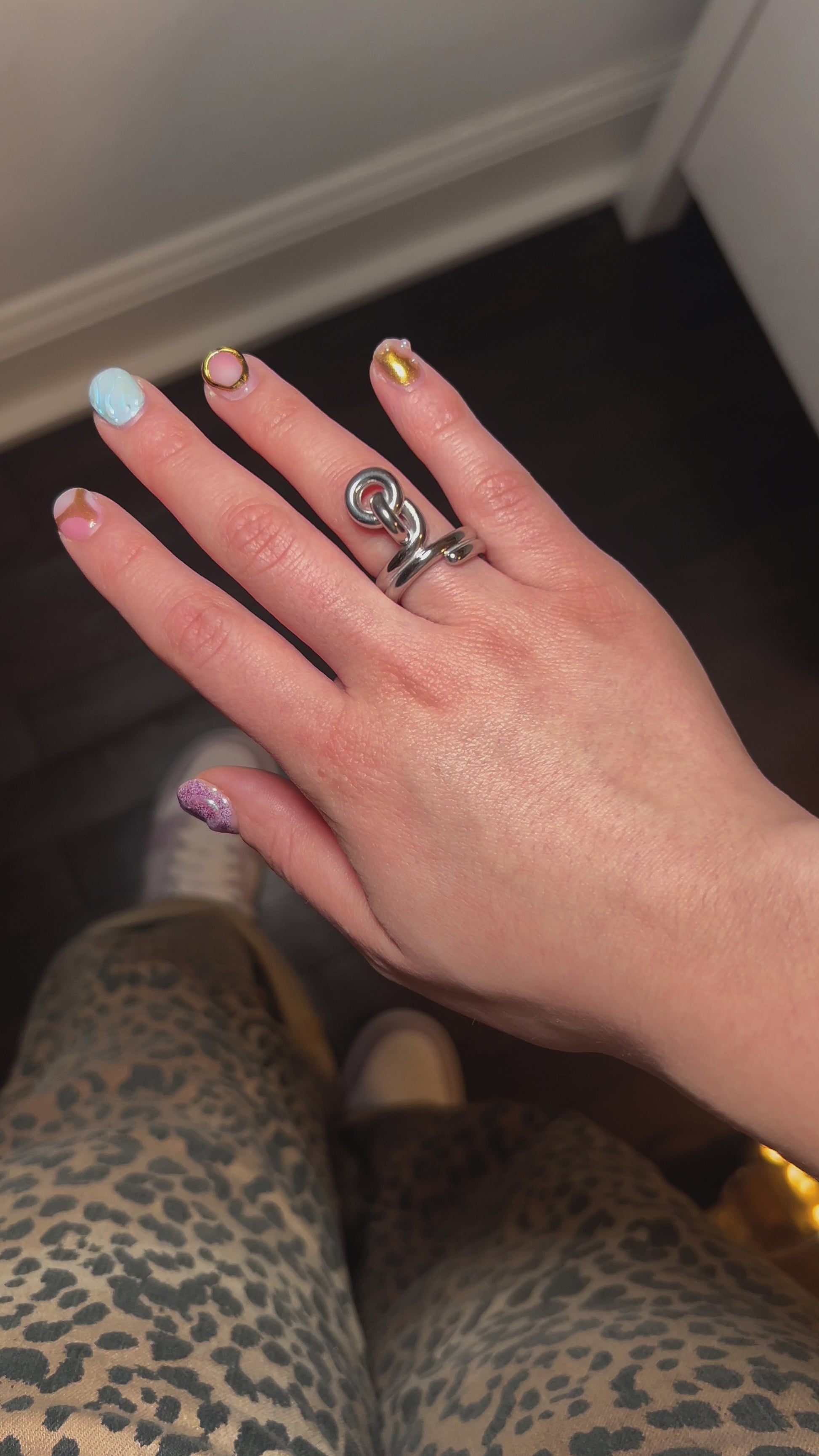 Gold-plated knot ring symbolizing love and unity – worn on hand