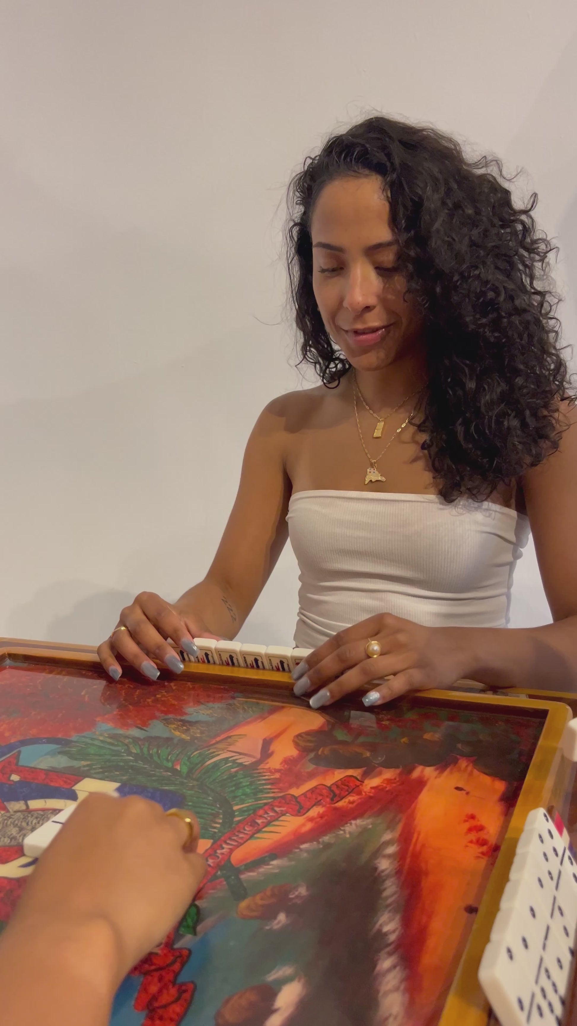 Layered Caribbean jewelry – waterproof DR map necklace at domino table