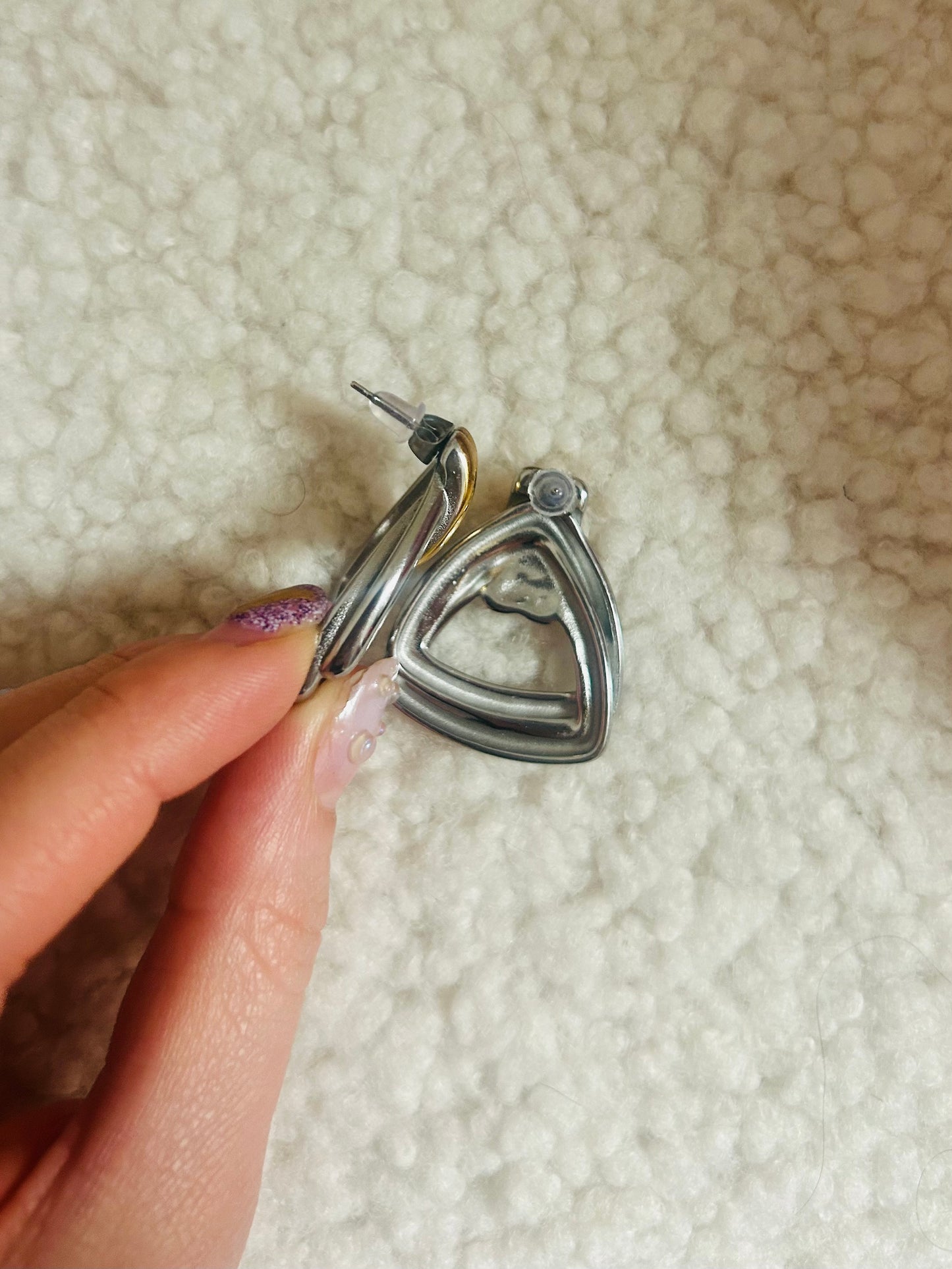 Side view of vintage-inspired earrings showing bold silhouette and shine