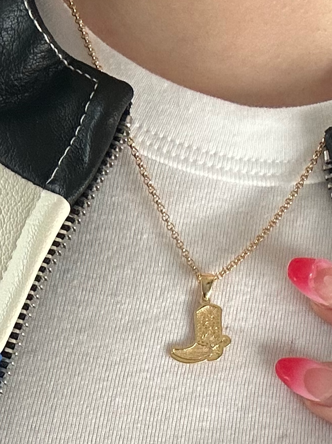 Close-up of stainless steel cowboy boot pendant