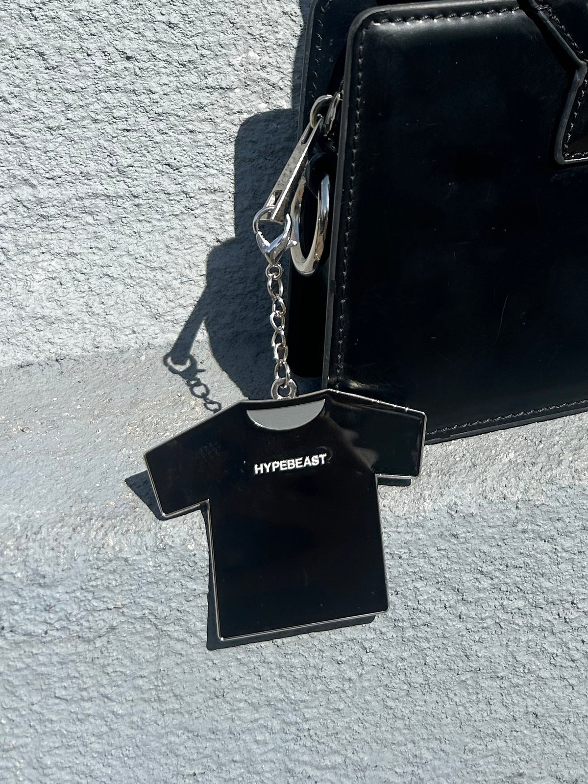 Black leather belt and wallet set on a textured gray surface
