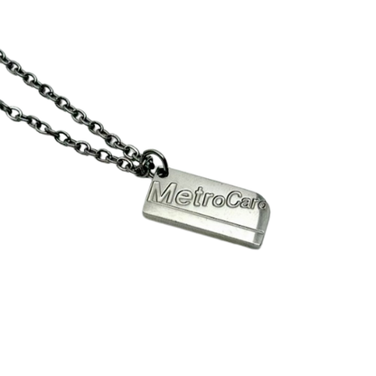 Silver necklace with a tag labeled 'MetroCar' on a white background