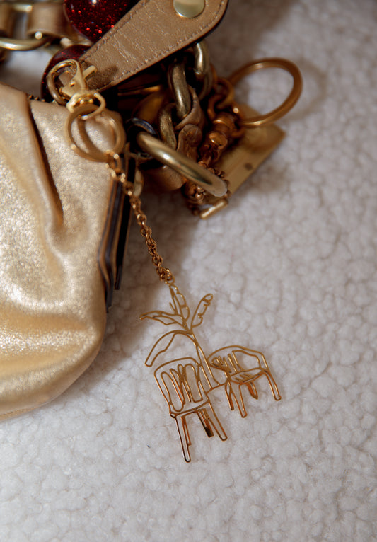 Detailed line-art palm tree and chairs bag charm for handbags or keys