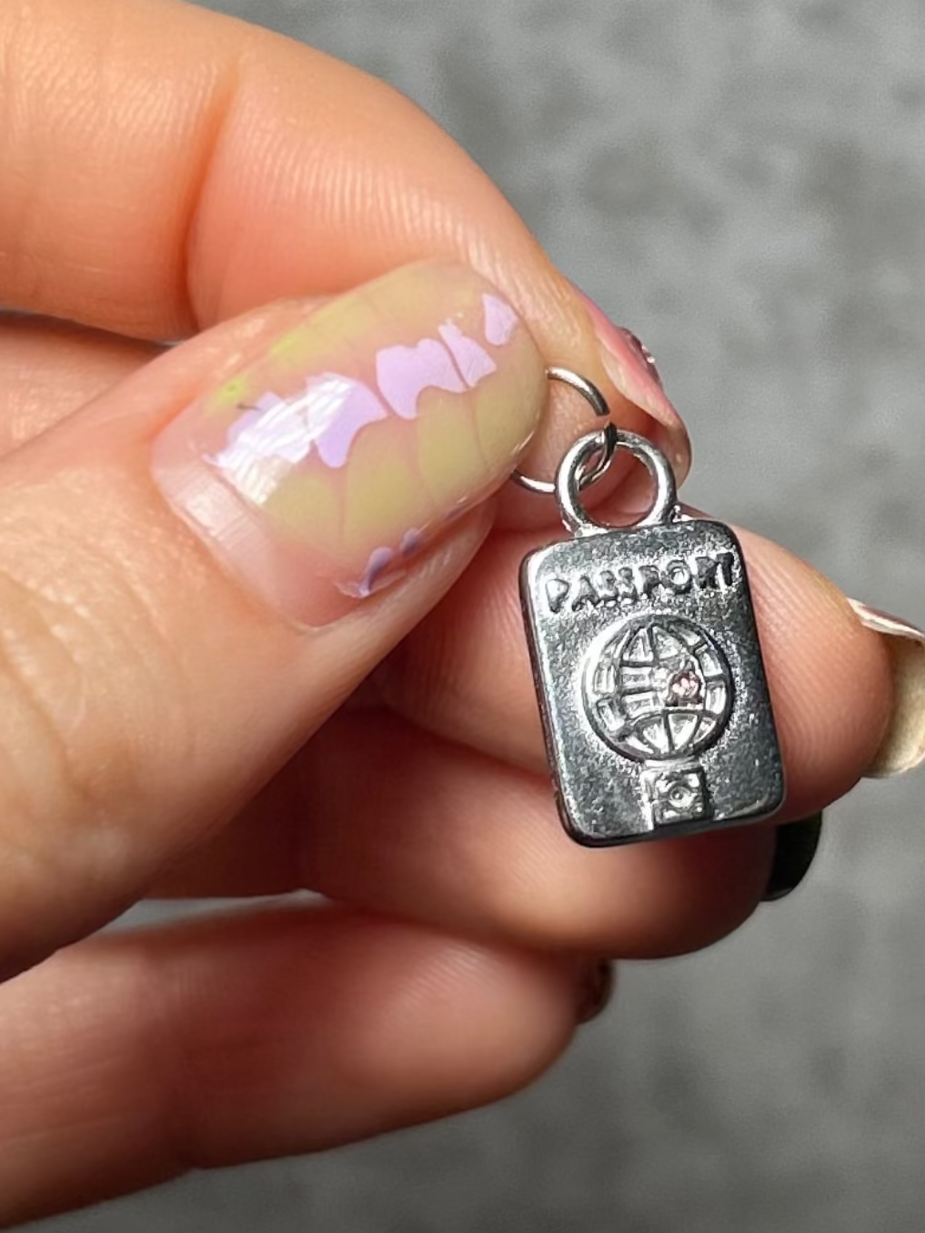 Passport Charm on gray background