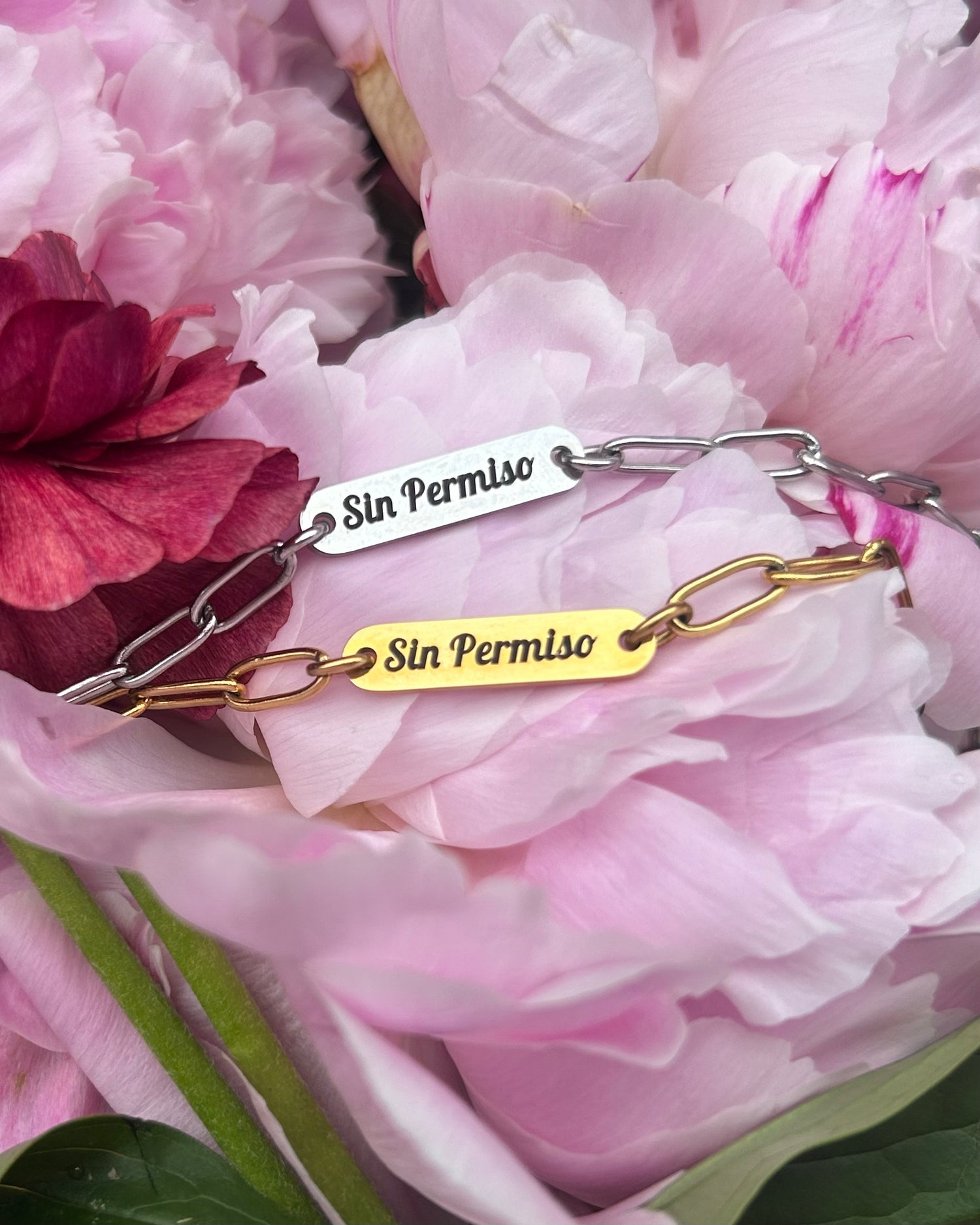 Silver and Gold Engraved Bracelet laying over a bed of flowers 