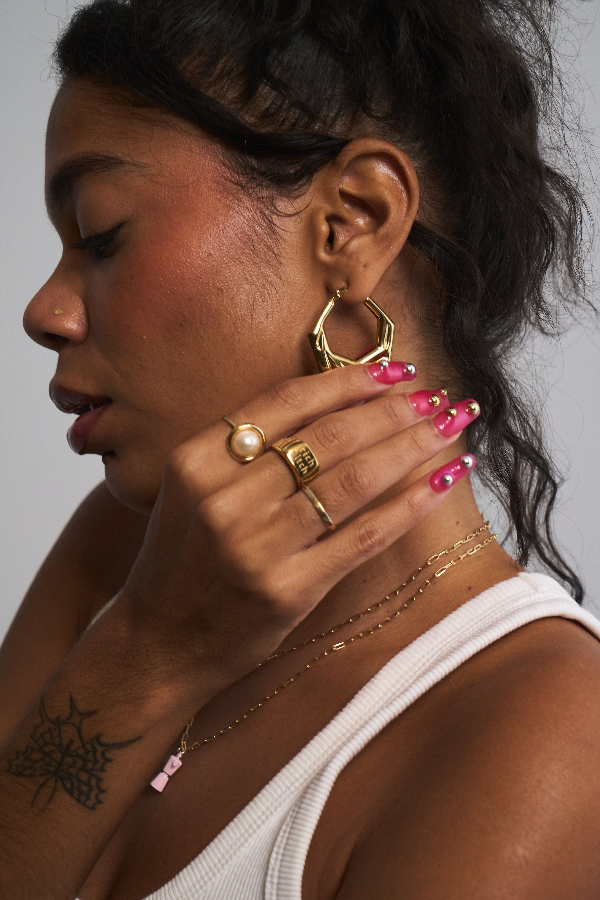 Close-up of gold angular hoop earrings with geometric silhouette