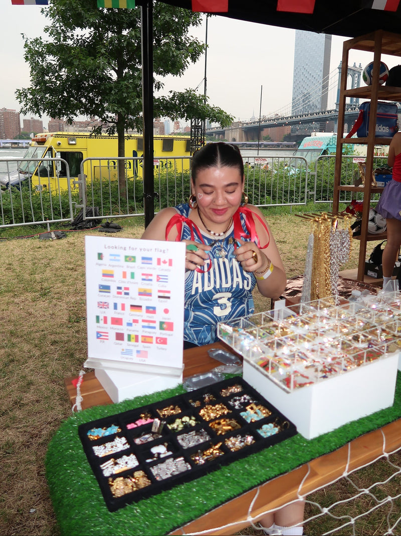 Woman at a outdoor retail space with various items on display