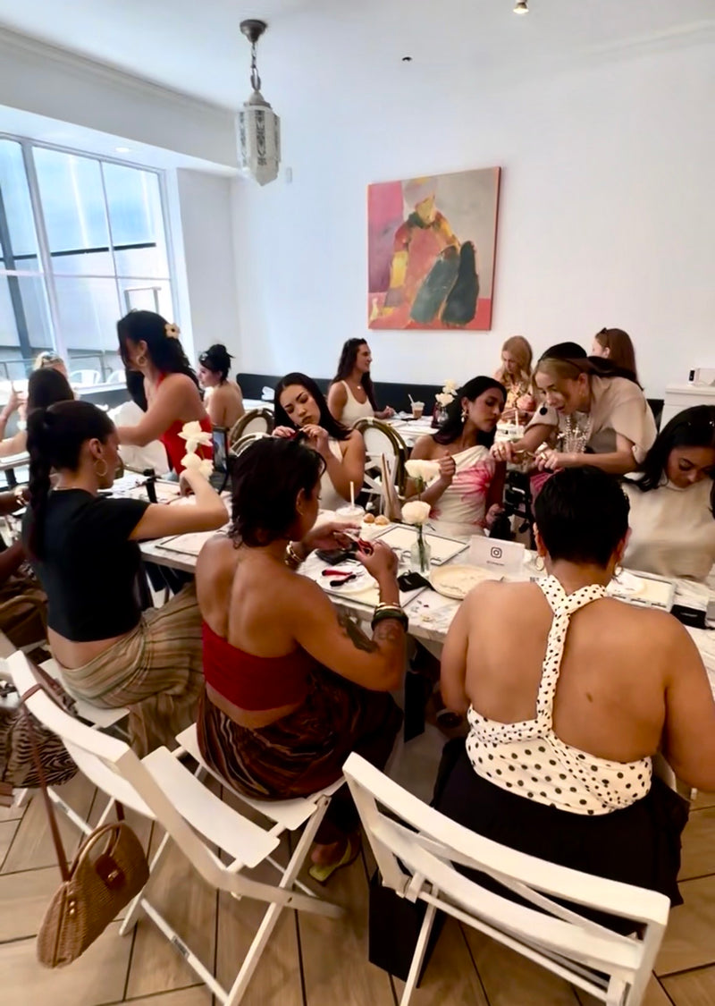 Group of women sitting at a table in a restaurant, engaged in conversation.