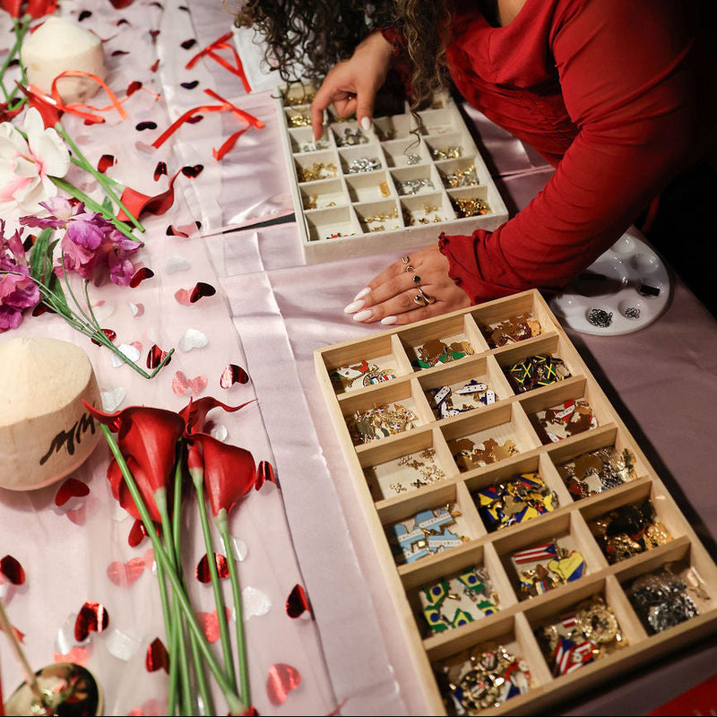 Woman arranging small containers on a table with decorative elements