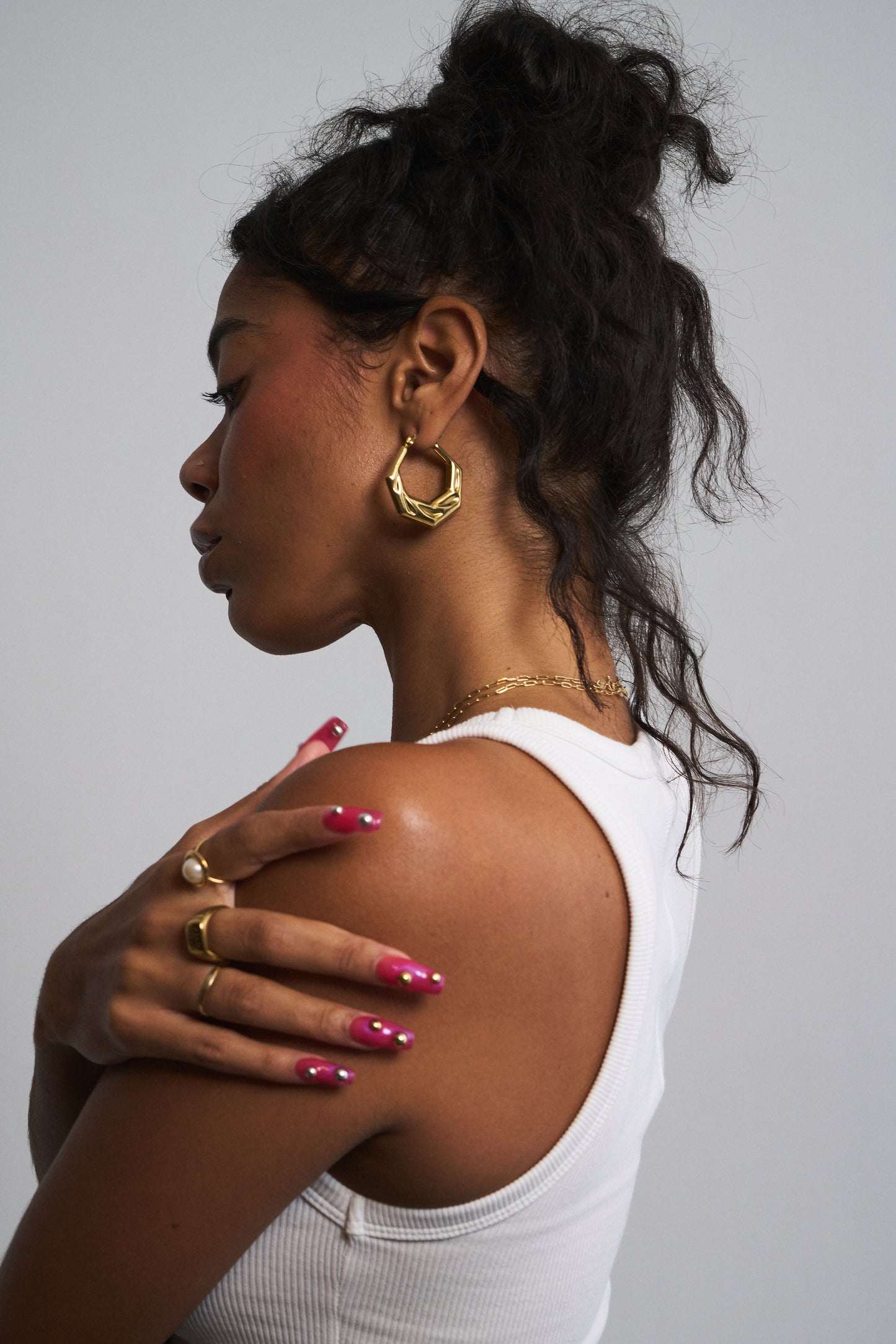Model wearing silver gold geometric huggie hoops – angular minimalist earrings