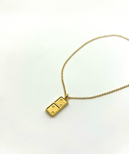 Close-up of domino necklace pendant with engraving