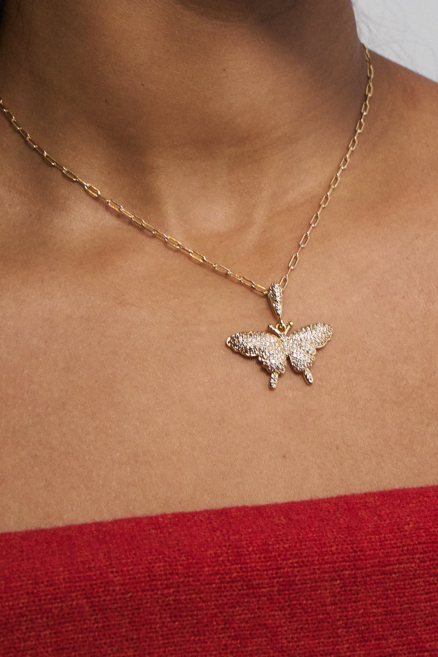 Waterproof butterfly necklace on neutral background