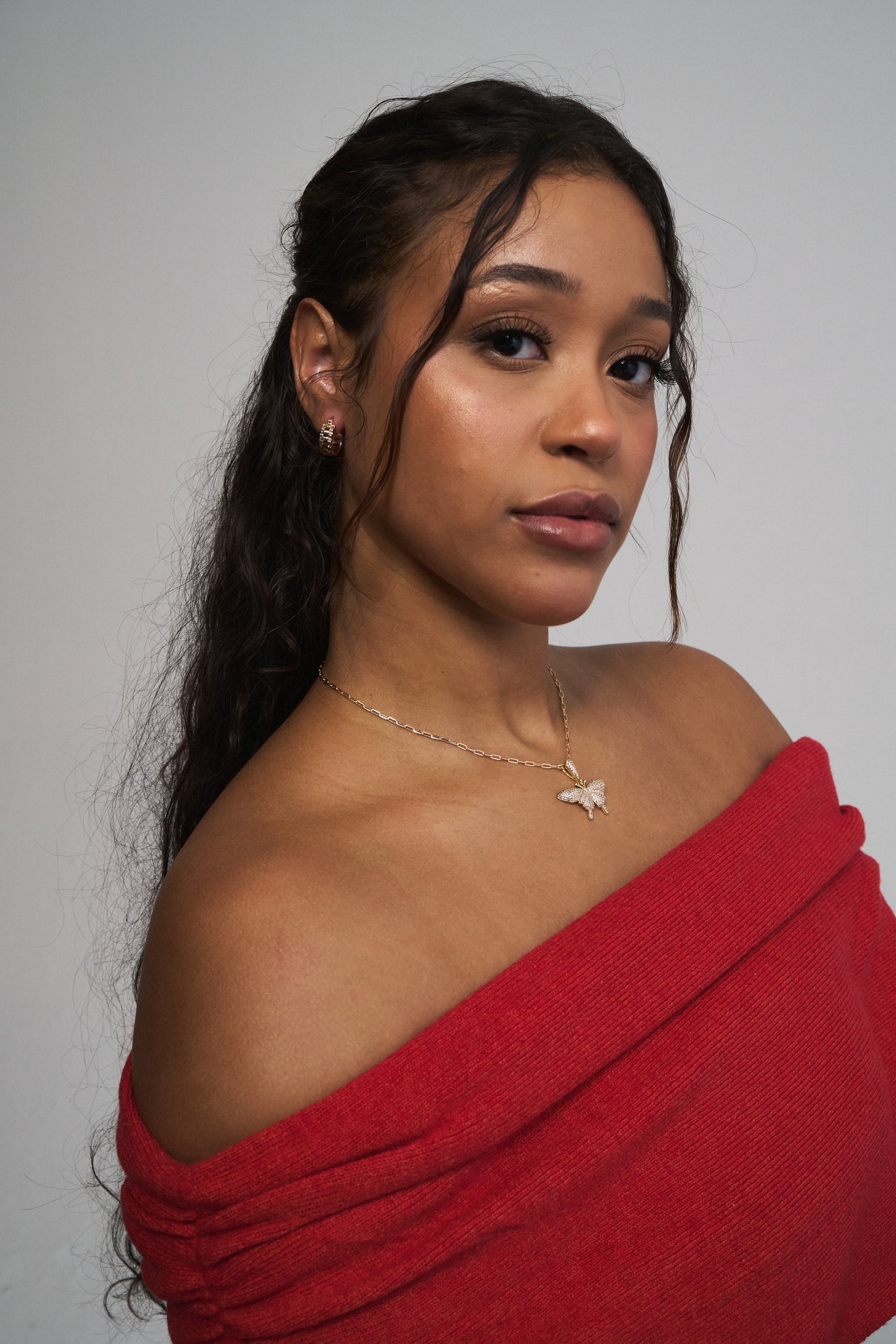 Gold butterfly pendant necklace on model – dainty layering style