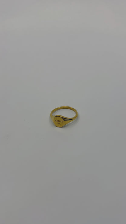 Flat lay of Latinx AF statement ring with gold accents