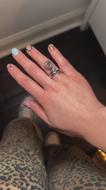 Gold-plated knot ring symbolizing love and unity – worn on hand