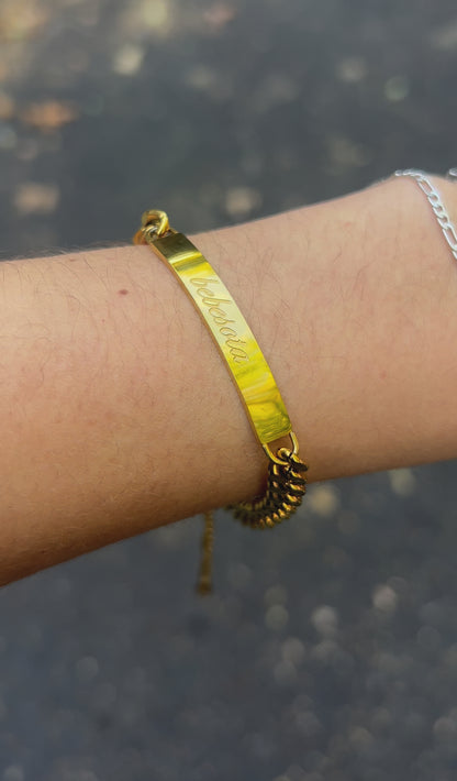 Gold Bebesota nameplate bracelet on model wrist – waterproof jewelry