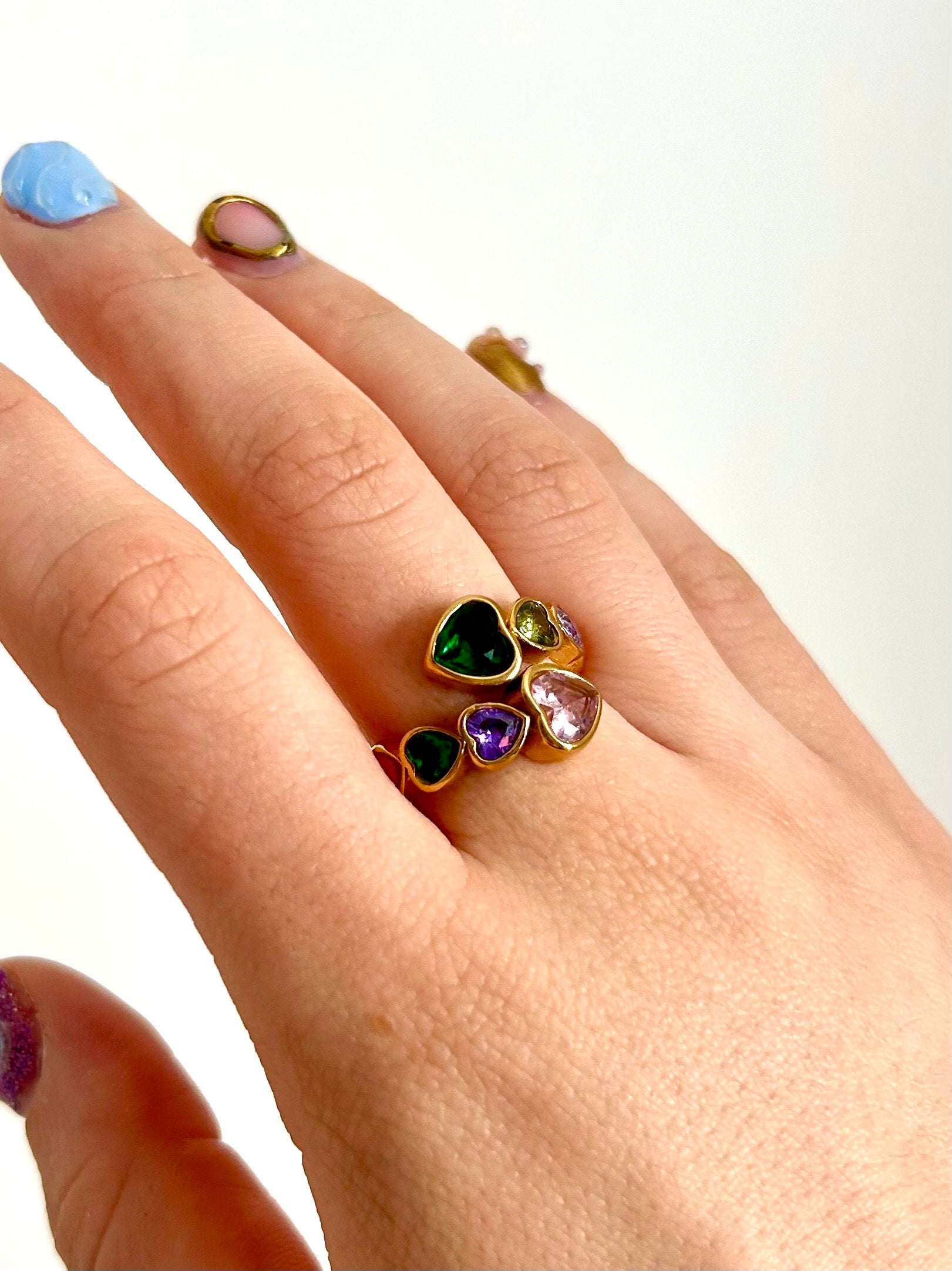 Gold-plated rainbow gemstone ring styled with stacked gold bands