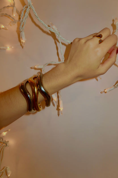 Stacked gold and silver bangles on arm – tarnish-free