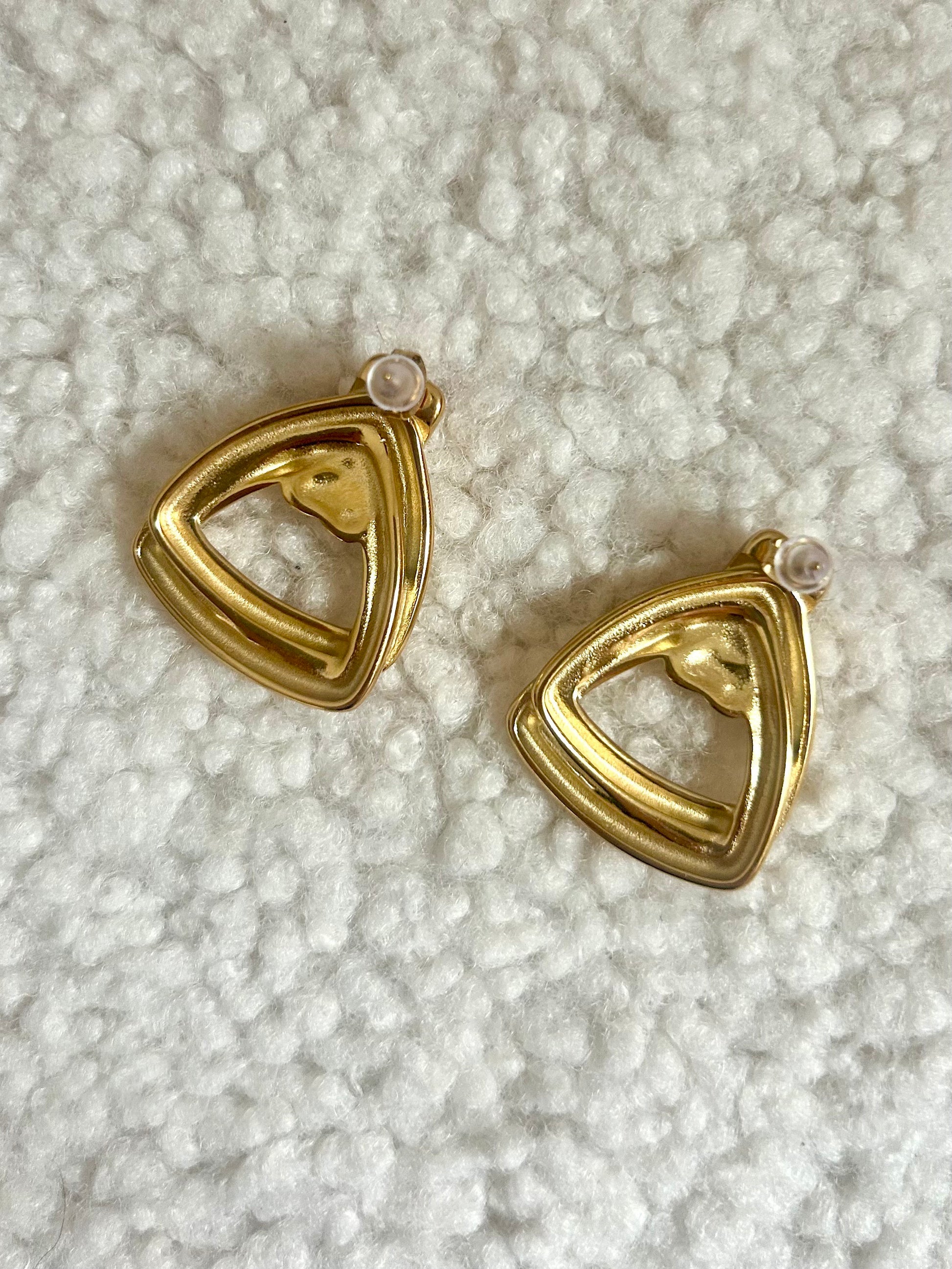 close up of vintage earrings on the back